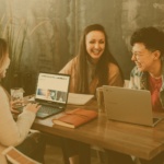 JD Scott + Co group of people in a startup working and laughing