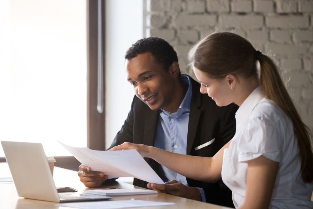 Female Financial Advisor Insurer Consulting Male African American Client About Contract